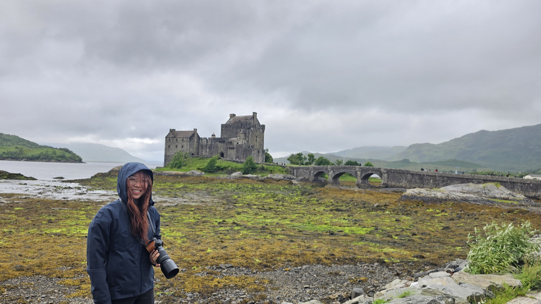 Tianyu with her camera in front of a Scottish castle